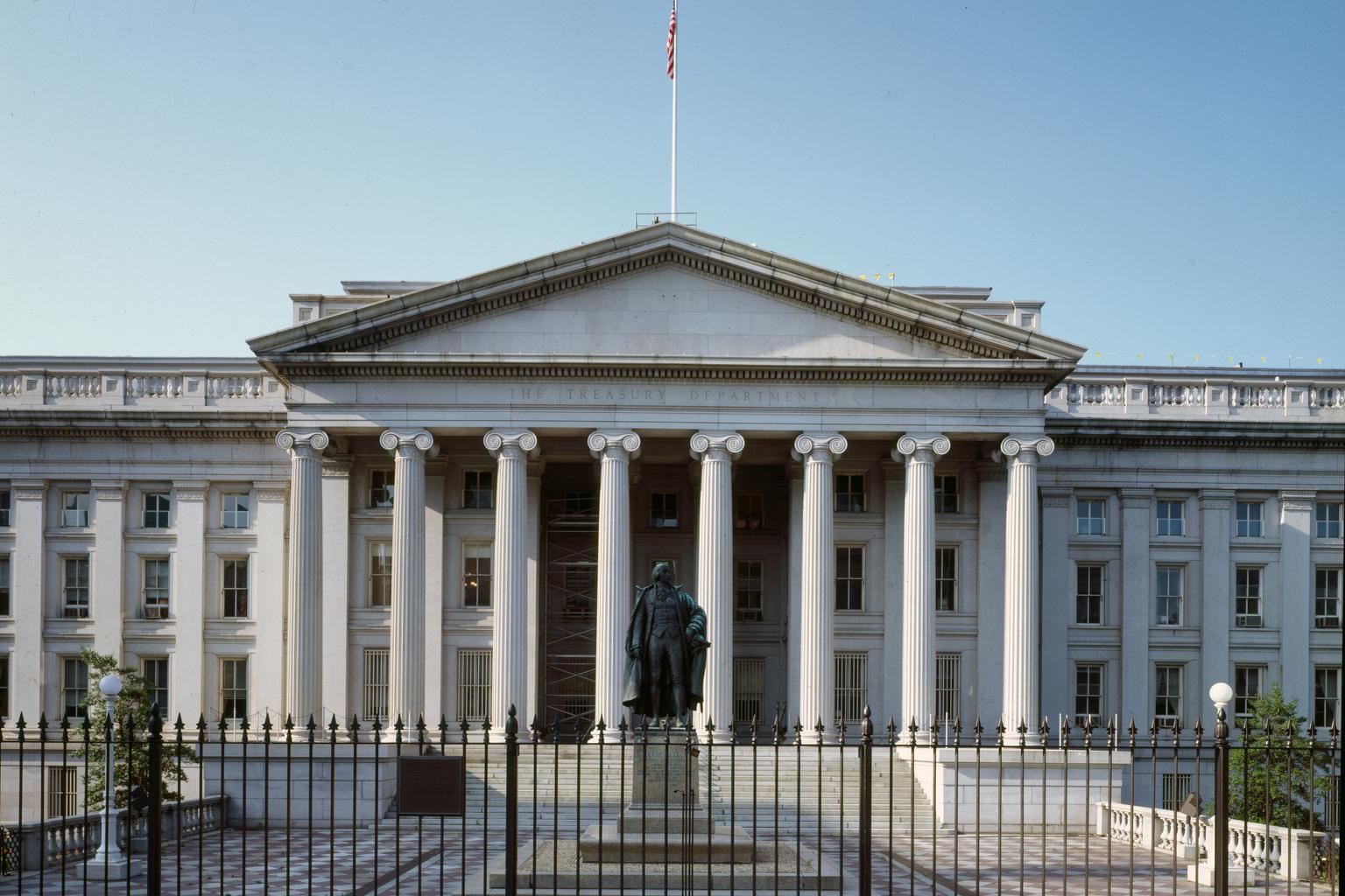 U.S. Treasury Department building in Washington, D.C., with its facade inscription and American flag.