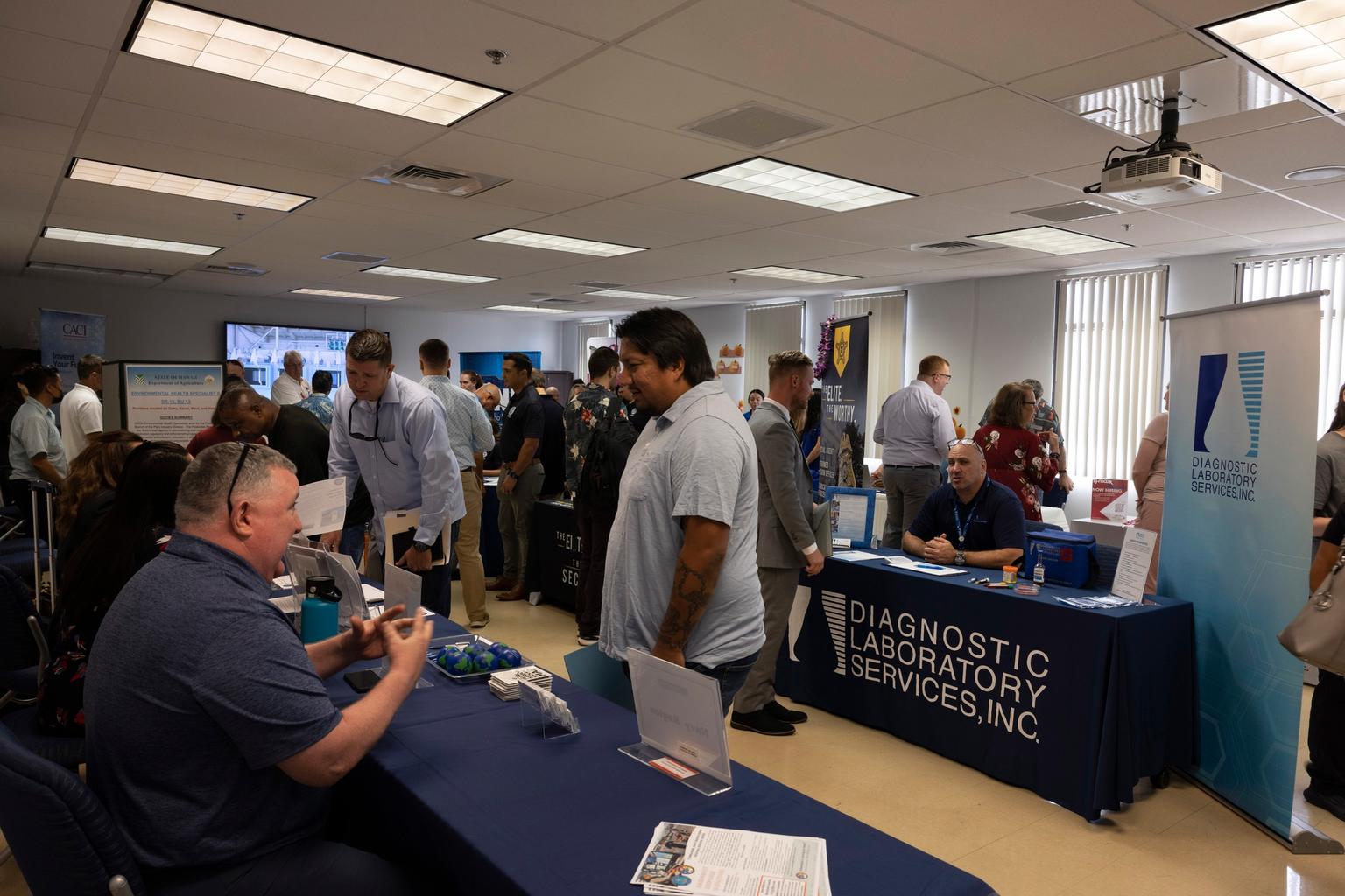 Job seekers and employers talk at a hiring fair at Joint Base Pearl Harbor-Hickam in Hawaii.