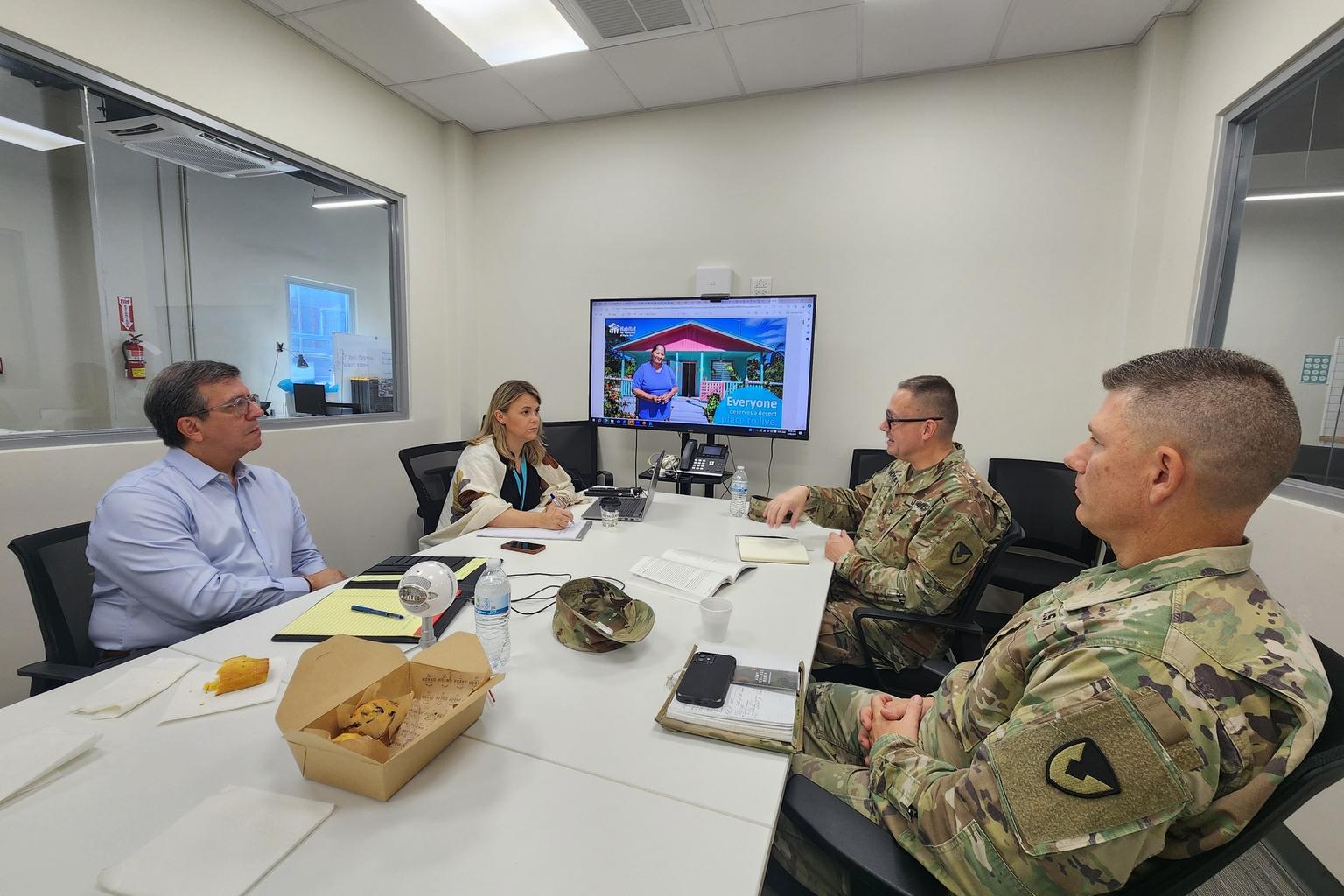 Habitat for Humanity executive director Amanda Silva and board secretary Jorge Morales meet with U.S. Army leaders at the nonprofit’s headquarters in Puerto Rico.