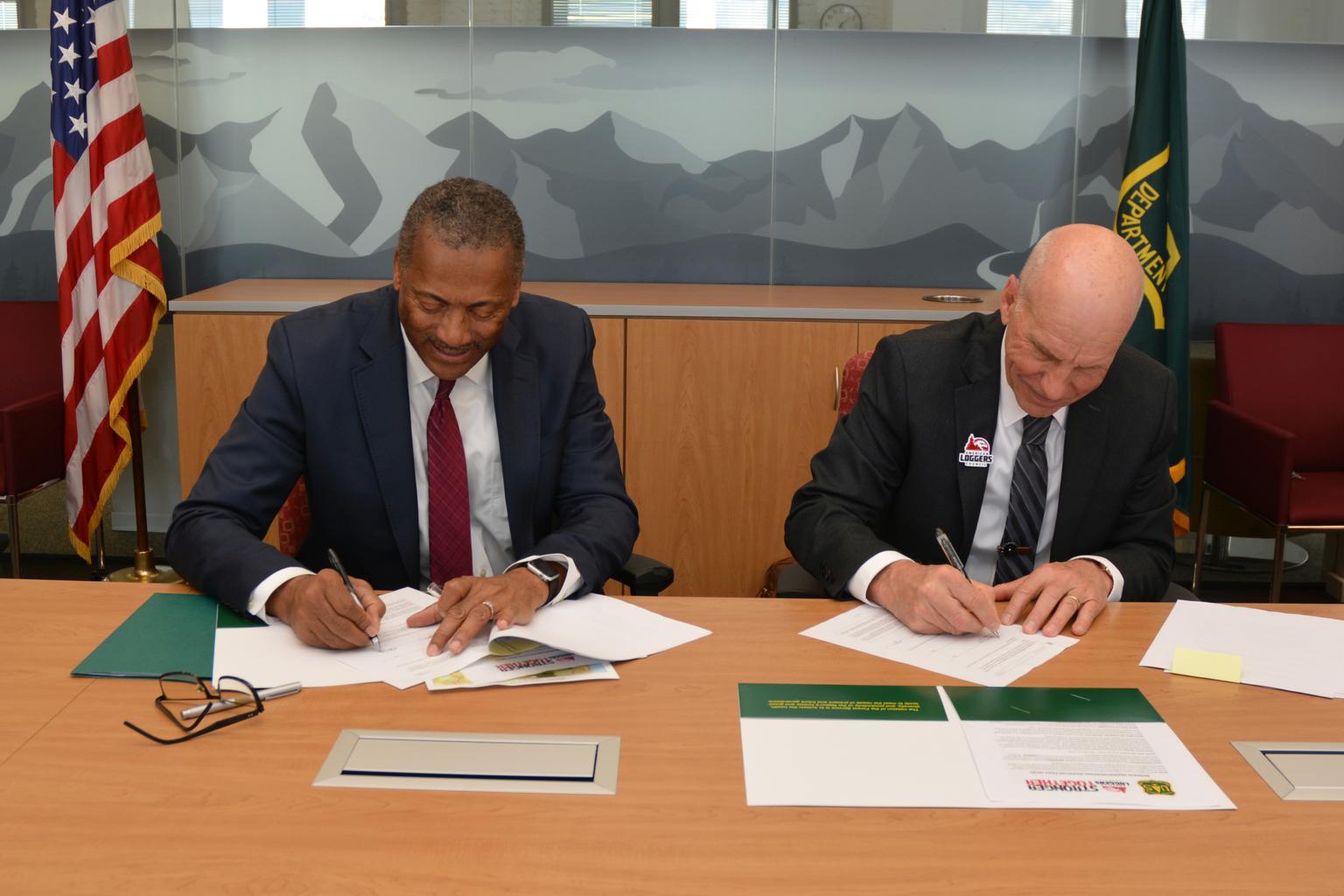 U.S. Forest Service Chief Randy Moore and American Loggers Council President Mike Albrecht sign a memorandum of understanding in Washington, D.C.