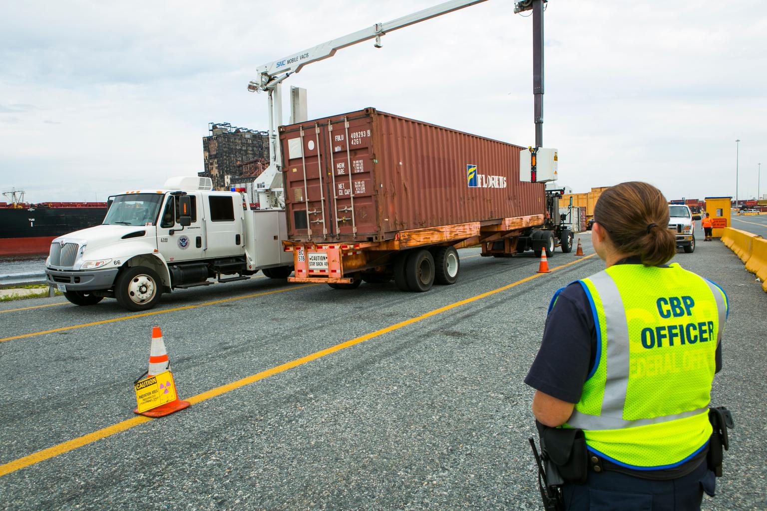 U.S. Customs and Border Protection officer watching a shipping-container inspection at the Port of Baltimore.