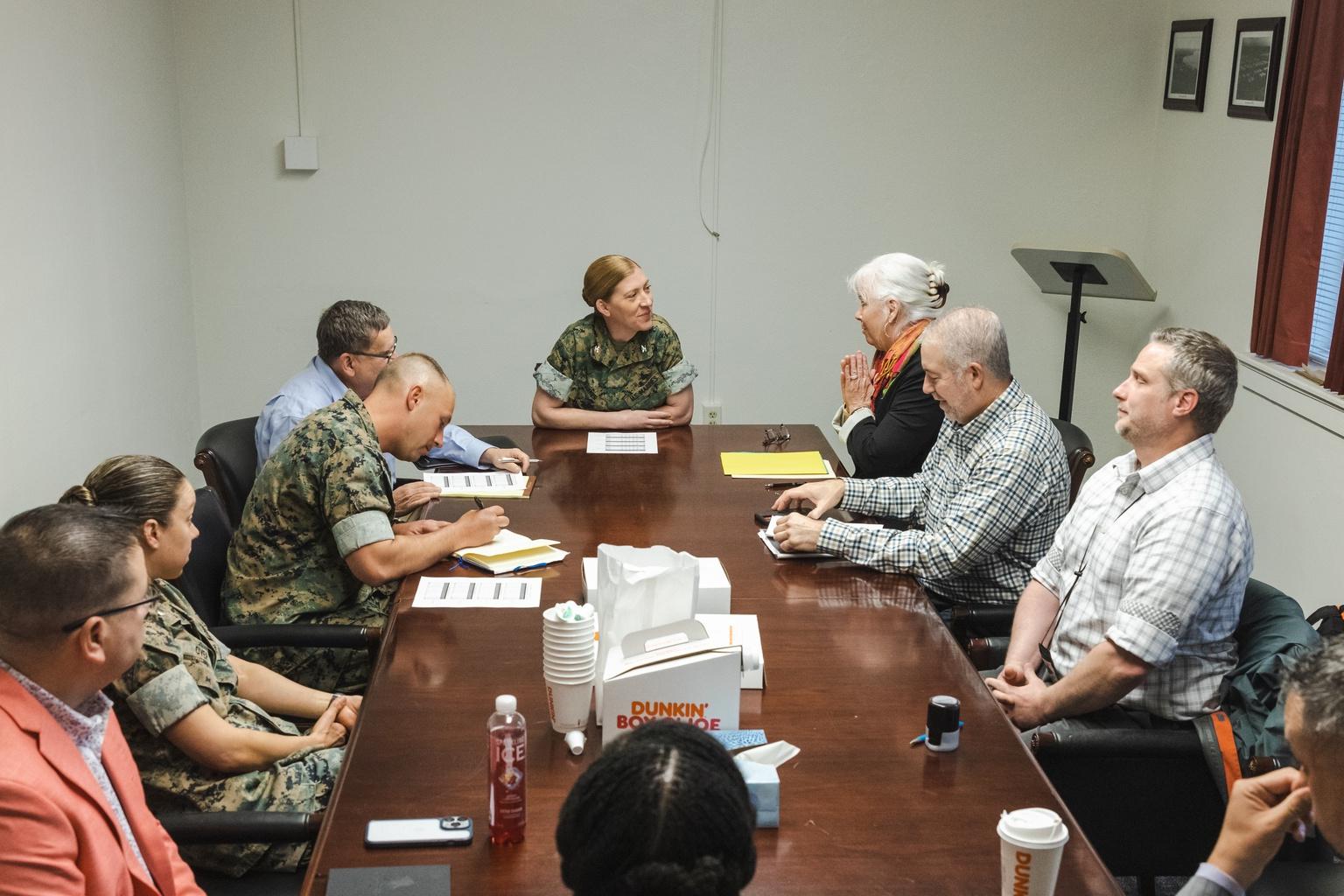 U.S. Marines and civilians sit around a table during a tax-center recognition meeting at Camp Lejeune, North Carolina.