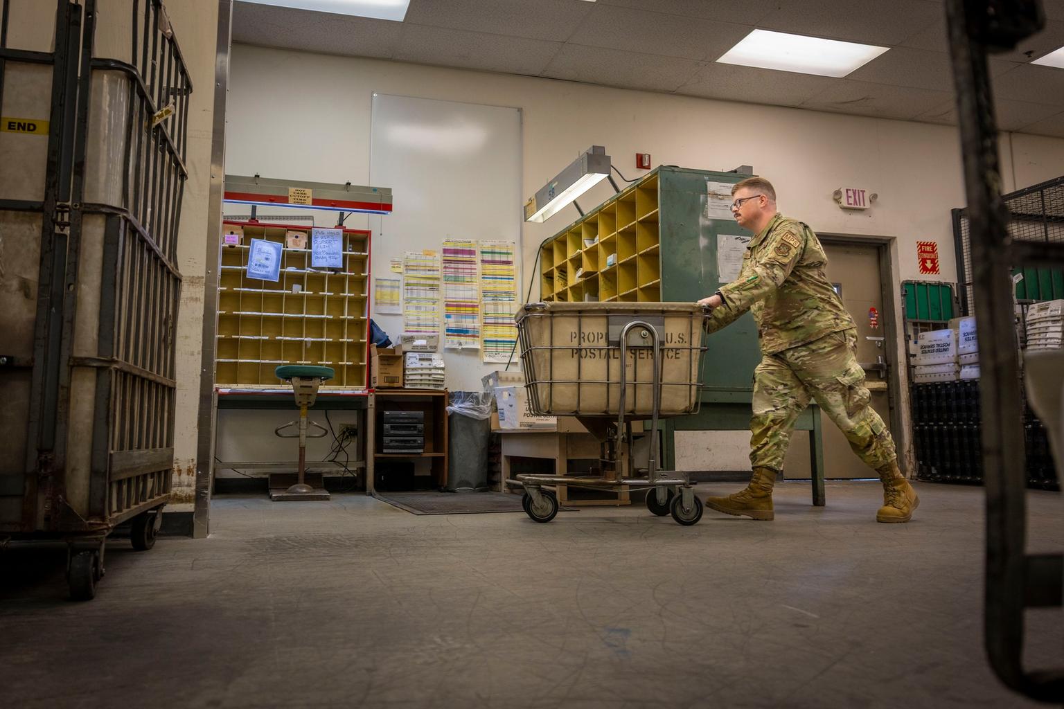 U.S. Air Force Staff Sgt. Darin Proffitt moves official mail through the postal center at MacDill Air Force Base in Tampa, Florida.
