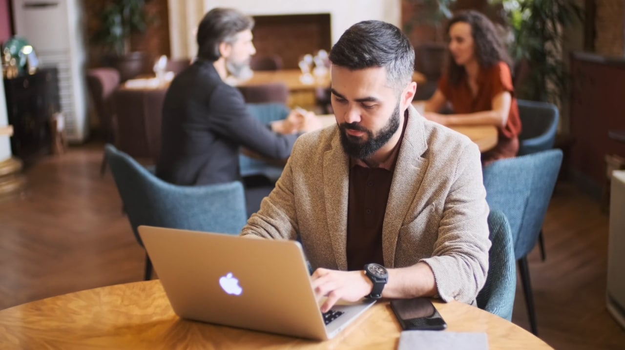 Person working on a laptop in a cafe